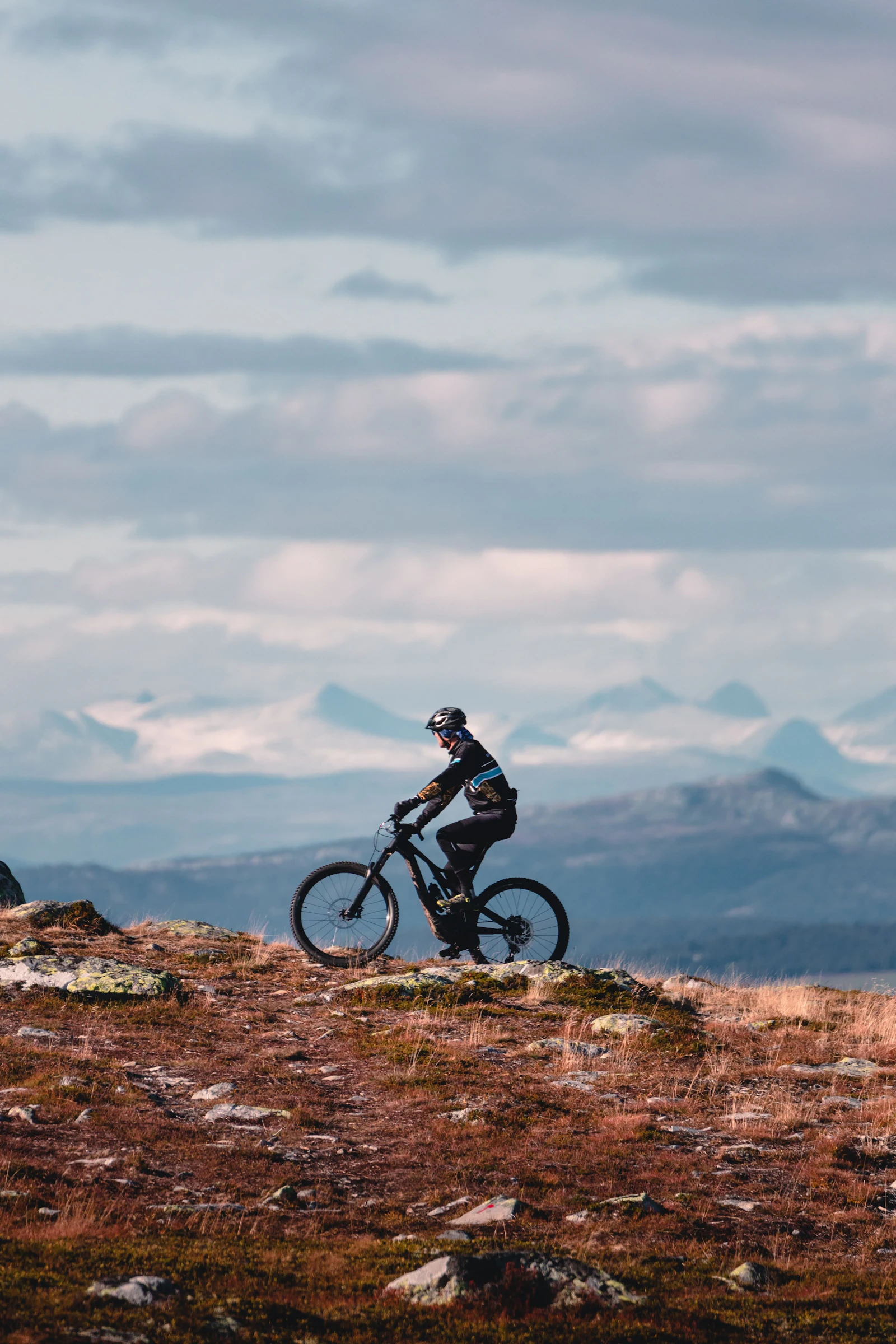 En cyklist på mountainbike i norskt fjällandskap