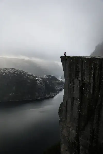 Preikestolens klippavsats över Lysefjorden i dimmigt väder