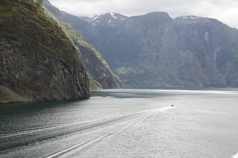 En båt på Sognefjorden mellan branta fjällsidor